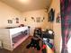 Bedroom with a bunk bed, wooden decor, and brown carpet at 541 Park Blvd, Brighton, CO 80603
