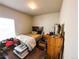 Bedroom with a bed, wood dresser, and items scattered around the room at 541 Park Blvd, Brighton, CO 80603