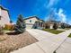 Well kept home with a large driveway, adjacent to green grass and rock features at 541 Park Blvd, Brighton, CO 80603