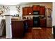 Well-lit kitchen features stainless steel appliances and dark wood cabinets at 541 Park Blvd, Brighton, CO 80603