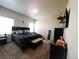 A primary bedroom with a king bed, dark furniture, and natural light coming through the windows at 541 Park Blvd, Brighton, CO 80603