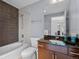 Bathroom with a bathtub, shower, and vanity with dark granite countertop at 891 14Th St # 1109, Denver, CO 80202