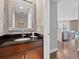 Modern bathroom with elegant mirror, dark granite counters, and hardwood floors at 891 14Th St # 1109, Denver, CO 80202