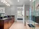 Bathroom featuring a double vanity, an enclosed bathtub, and modern lighting at 891 14Th St # 1109, Denver, CO 80202