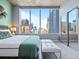 Bedroom with a large window, cityscape view, and modern décor at 891 14Th St # 1109, Denver, CO 80202