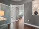 Hallway featuring hardwood floors, gray walls, and an alcove with decorative vase at 891 14Th St # 1109, Denver, CO 80202