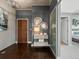 Hallway showcasing hardwood floors, decorative mirrors, and stylish console table at 891 14Th St # 1109, Denver, CO 80202