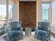 Stylish sitting area featuring two patterned armchairs and city views at 891 14Th St # 1109, Denver, CO 80202