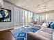 Spacious living room with hardwood floors, expansive windows, and stylish decor with city views at 891 14Th St # 1109, Denver, CO 80202