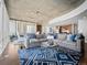 Modern living room boasts an open floor plan, large sectional sofa, and cityscape views at 891 14Th St # 1109, Denver, CO 80202