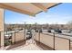 Balcony view showing parking lot filled with parked cars and open sky in the distance at 800 W Belleview Ave # 201, Englewood, CO 80110