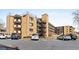 Multi-level brick apartment building with balconies and parking at 800 W Belleview Ave # 201, Englewood, CO 80110