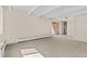 Spacious living room with carpet and sliding door to patio at 800 W Belleview Ave # 201, Englewood, CO 80110