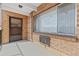 Patio features brick facade, large window, and front door at 800 W Belleview Ave # 201, Englewood, CO 80110
