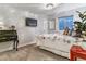 Comfortable bedroom with neutral carpet, TV, stylish black desk, and decoratively covered queen-sized bed at 566 N Humboldt St, Denver, CO 80218