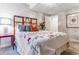 Bedroom with an elaborate headboard, side table, and stylishly made queen-sized bed with decorative cover at 566 N Humboldt St, Denver, CO 80218
