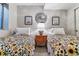 Cozy bedroom with twin beds, a central nightstand, stylish lamps, and decoratively framed wall art at 566 N Humboldt St, Denver, CO 80218