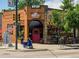 Charming neighborhood cafe with a scooter parked outside, vibrant murals, and outdoor seating at 566 N Humboldt St, Denver, CO 80218