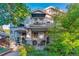 Charming two-story home featuring dual balconies, manicured landscaping, and an inviting front porch at 566 N Humboldt St, Denver, CO 80218