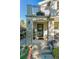 Welcoming front steps and porch with detailed ironwork and lush greenery, creating a warm entry at 566 N Humboldt St, Denver, CO 80218