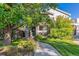 Beautifully landscaped front yard with mature trees and a winding walkway leading to the welcoming entrance at 566 N Humboldt St, Denver, CO 80218