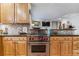 Close up on a kitchen with light wood cabinets, stone countertops, and a stainless steel range at 566 N Humboldt St, Denver, CO 80218