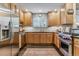 Modern kitchen with stainless steel appliances, light wood cabinets, and stylish tile backsplash at 566 N Humboldt St, Denver, CO 80218