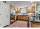 Well-lit kitchen featuring stainless steel appliances, wood cabinets, and an island with a stone countertop at 566 N Humboldt St, Denver, CO 80218