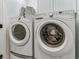 This laundry room features white front load washing and drying machines at 566 N Humboldt St, Denver, CO 80218