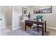 This home office features carpeted floors, a wooden desk, and natural light at 566 N Humboldt St, Denver, CO 80218