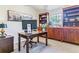 This home office features carpeted floors, a wooden desk, and built in bookcases at 566 N Humboldt St, Denver, CO 80218