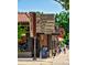 Neighborhood corner shop with a retro sign, outdoor seating, and an inviting storefront at 566 N Humboldt St, Denver, CO 80218