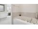 Inviting bathroom featuring a tiled soaking tub and bright windows at 11386 Grove St # B, Westminster, CO 80031