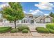 Inviting townhome with white picket fence, lush landscaping, and a charming entryway at 11386 Grove St # B, Westminster, CO 80031