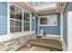 Charming blue home entrance featuring a welcome mat, flower pot, and stone accents at 11386 Grove St # B, Westminster, CO 80031