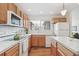 This kitchen boasts wooden cabinets, hardwood floors, and a view to the outside at 11386 Grove St # B, Westminster, CO 80031
