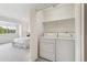 Bright laundry closet with washer and dryer next to a bedroom at 11386 Grove St # B, Westminster, CO 80031
