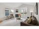 Bright living room with large windows, fireplace, and comfortable seating at 11386 Grove St # B, Westminster, CO 80031