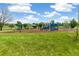 Neighborhood playground with various climbing and sliding structures in a grassy, open area at 11386 Grove St # B, Westminster, CO 80031