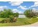 Relaxing view of pond with green bench and abundant trees along a meandering sidewalk at 11386 Grove St # B, Westminster, CO 80031