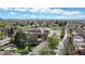 Expansive aerial view of a neighborhood with lush greenery, mature trees and nearby schools at 1960 S Sherman St, Denver, CO 80210