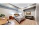 Modern bedroom with a queen-sized bed, a sofa, and ample natural light at 1960 S Sherman St, Denver, CO 80210