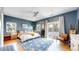Bedroom with hardwood floors, a king-sized bed, and a private balcony at 1960 S Sherman St, Denver, CO 80210