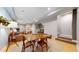 Open-concept dining area with wood floors, a modern table set, and seamless access to the living space at 1960 S Sherman St, Denver, CO 80210