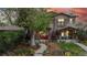 Charming two-story home featuring a stone facade, inviting front porch, and beautifully landscaped front yard at 1960 S Sherman St, Denver, CO 80210
