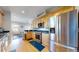 Modern kitchen with stainless steel appliances, wooden cabinets, and a view to the living room at 1960 S Sherman St, Denver, CO 80210