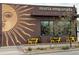 Exterior view of Maria Empanada restaurant featuring a mural of a sun at 1960 S Sherman St, Denver, CO 80210