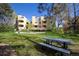 Exterior view of landscaped community space with green grass, dandelions, and a picnic table at 2711 Mapleton Ave # 1, Boulder, CO 80304
