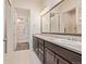 Spacious bathroom featuring double sinks and ample cabinet storage at 25019 E Alder Dr, Aurora, CO 80016