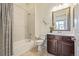 Bathroom featuring a vanity with a mirror, a toilet, and a shower-tub combination with curtain at 25019 E Alder Dr, Aurora, CO 80016